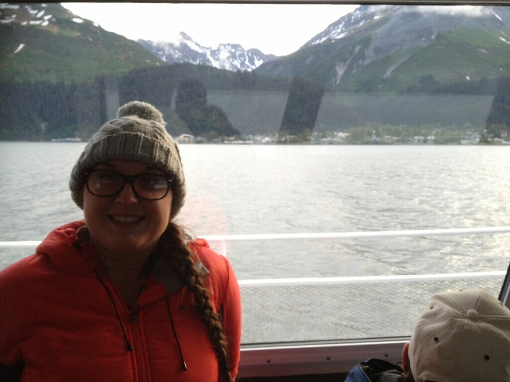 A woman enjoying a Kenai Fjords cruise