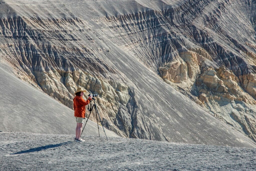 Photographer capturing a photo of the Ubehebe Crater in Death Valley