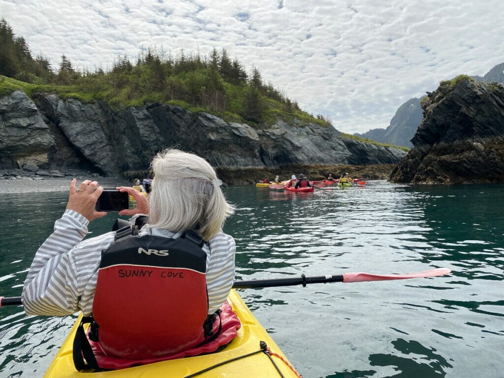 A woman kayaking around Fox Island