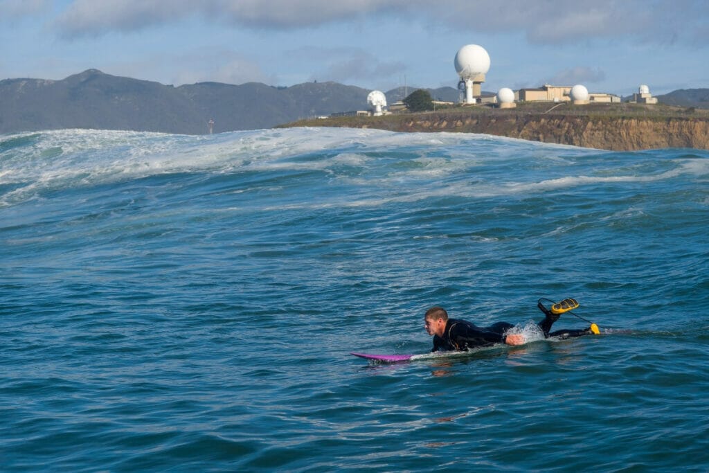 Image of a surfer hitting the waves in Moss Beach, California
