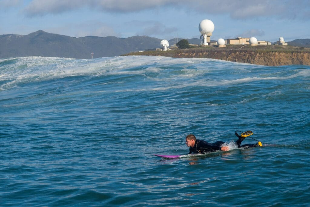 Image of a surfer hitting the waves in Moss Beach, California 