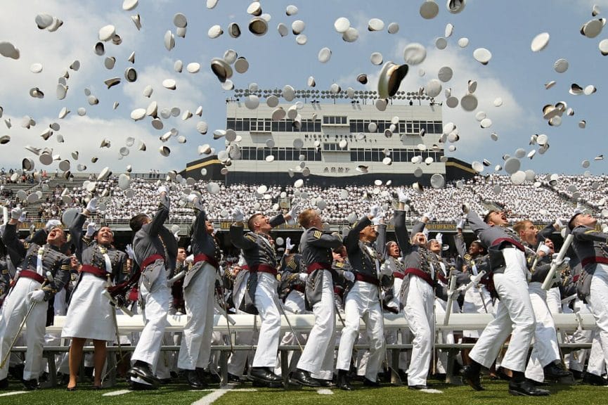 Graduates of West Point tossing their hats 