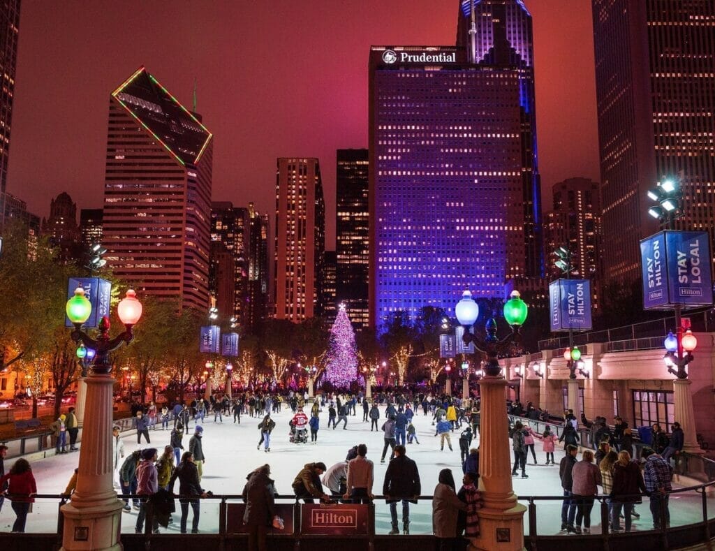 People ice skating at the McCormick Tribune Plaza Ice Rink in Chicago's Millennium Park