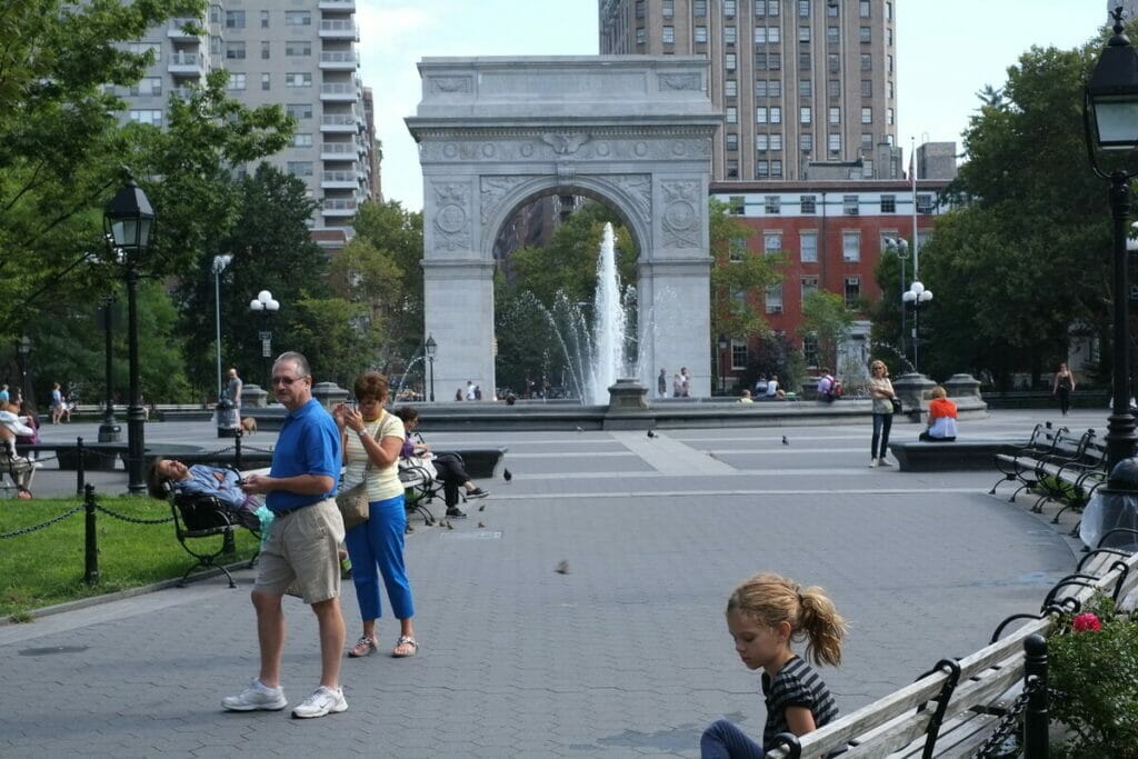 People walking around Washington Square Park 