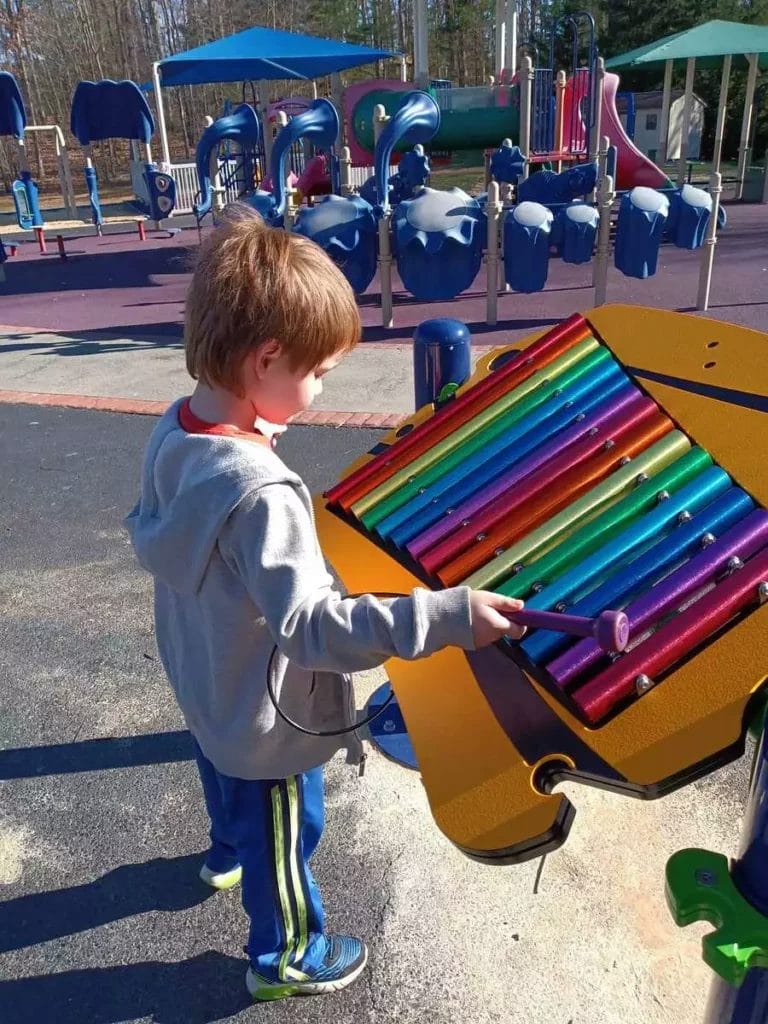 Kid playing at A Dream Come True Playground in Harrisonburg