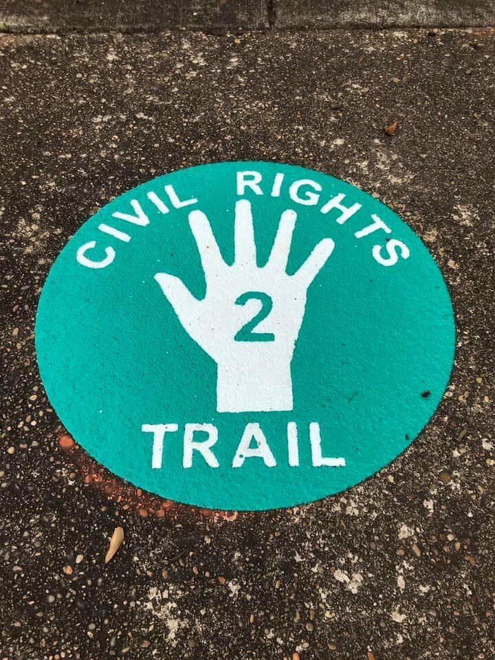 Painted icon on asphalt that marks a stop along the Tuscaloosa Civil Rights Trail