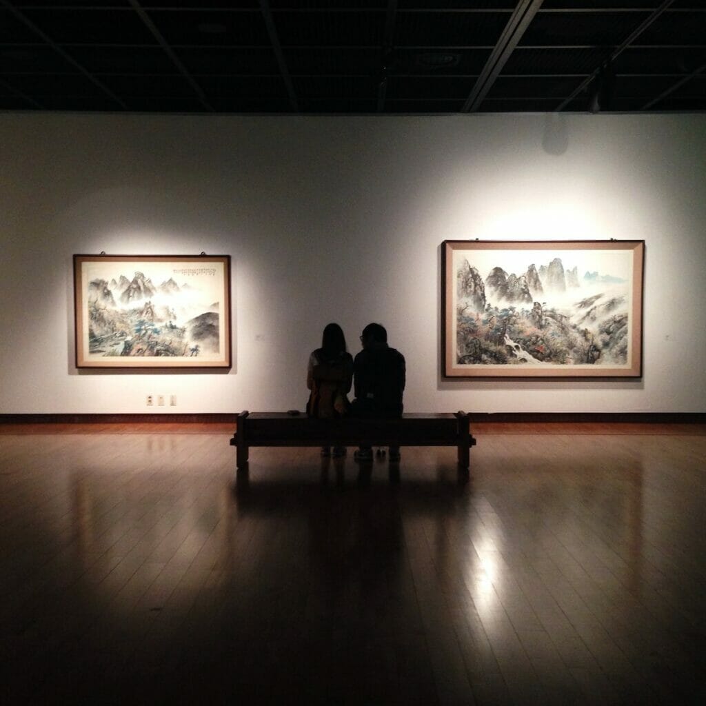 A couple sitting in an art gallery