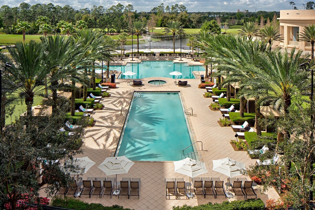 Exterior of the Waldorf Astoria Orlando hotel with a beautiful view of the pool area.