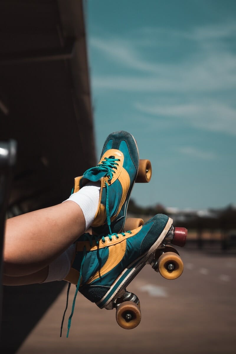 Teal and yellow colored roller skates