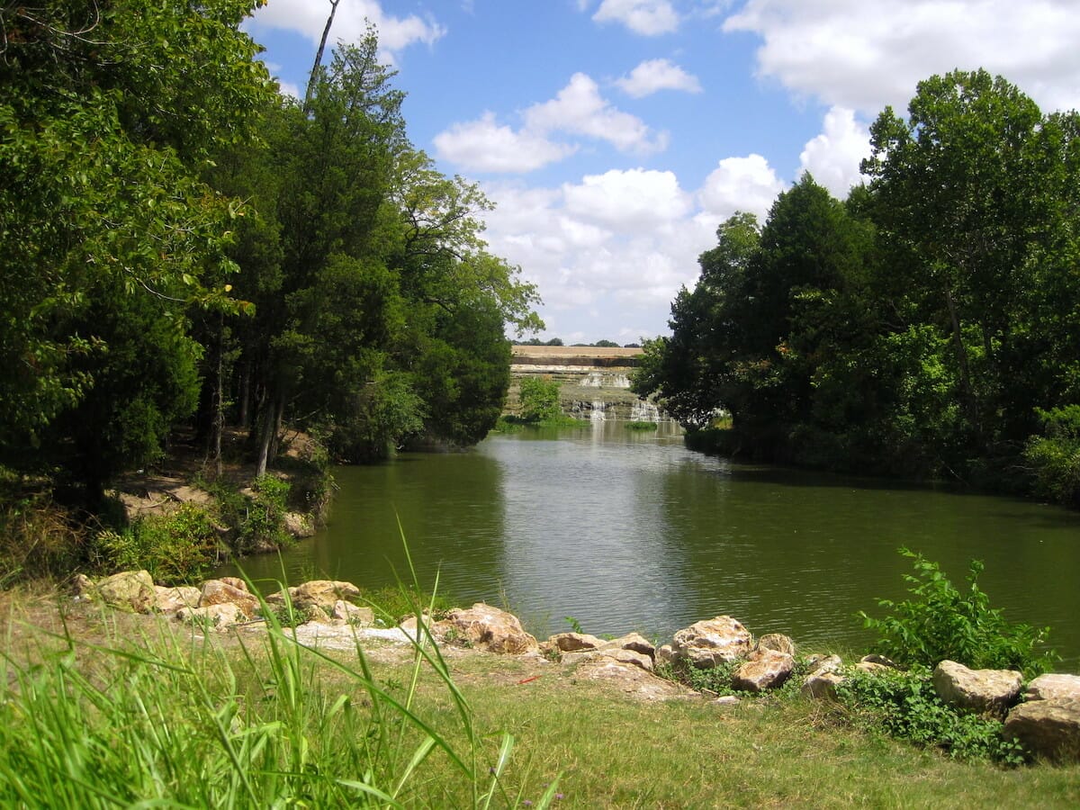 Lush greenery along the shoreline at White Rock Lake in Dallas Texas