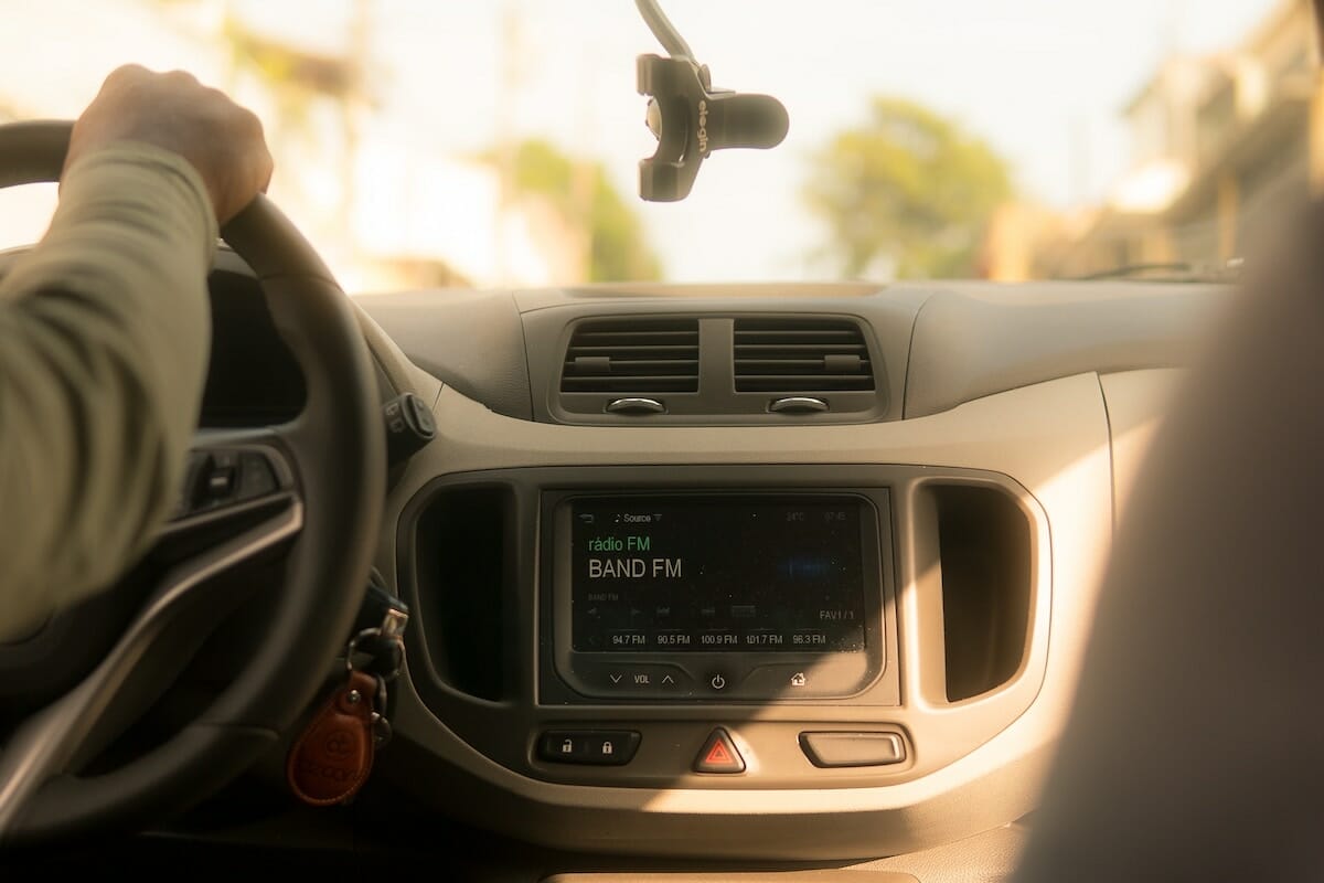 View of a car radio showing an FM radio station playing