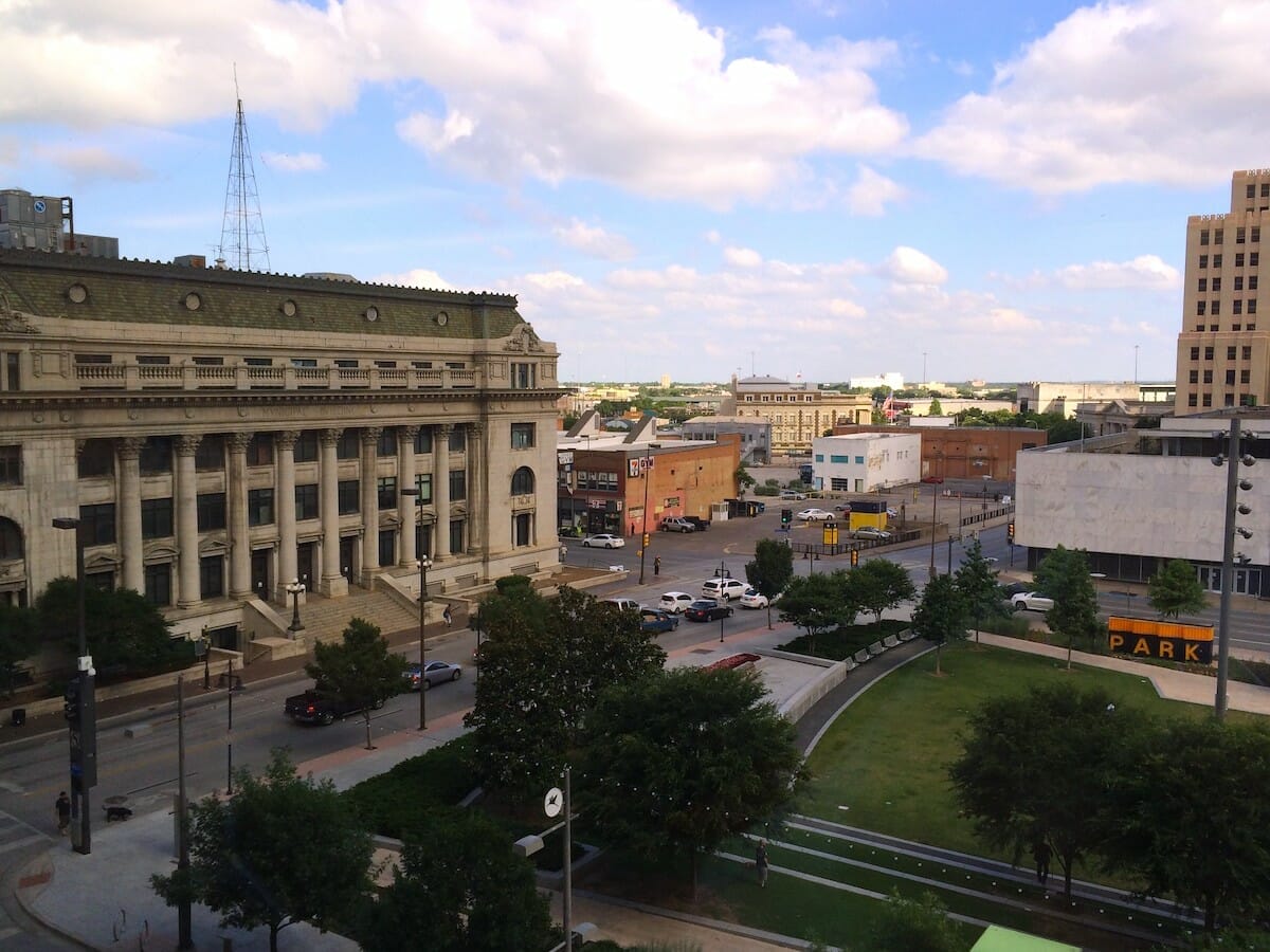 View of the Main Street Garden park in Downtown Dallas, with buildings across the street.