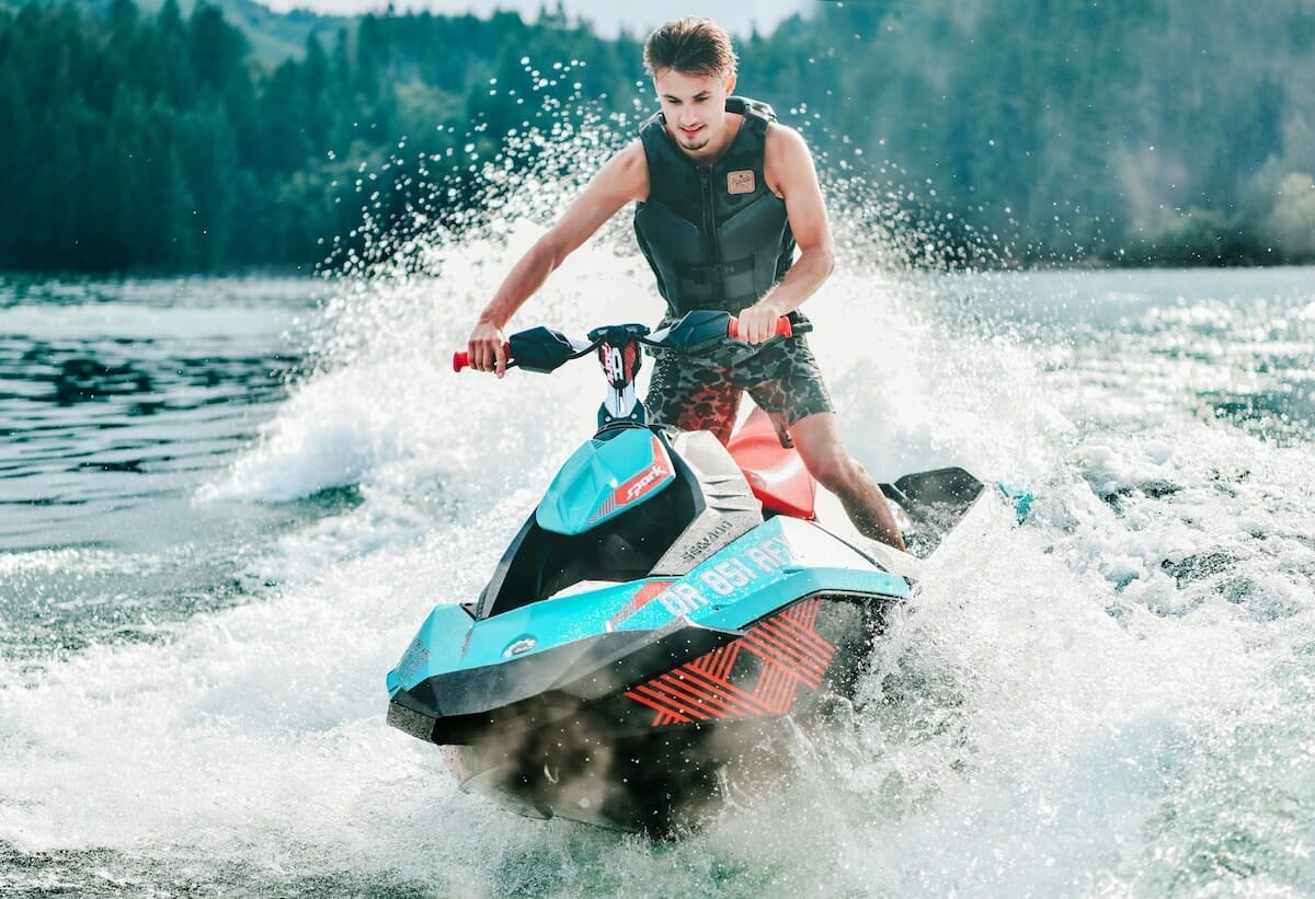 person riding a jet ski on a lake