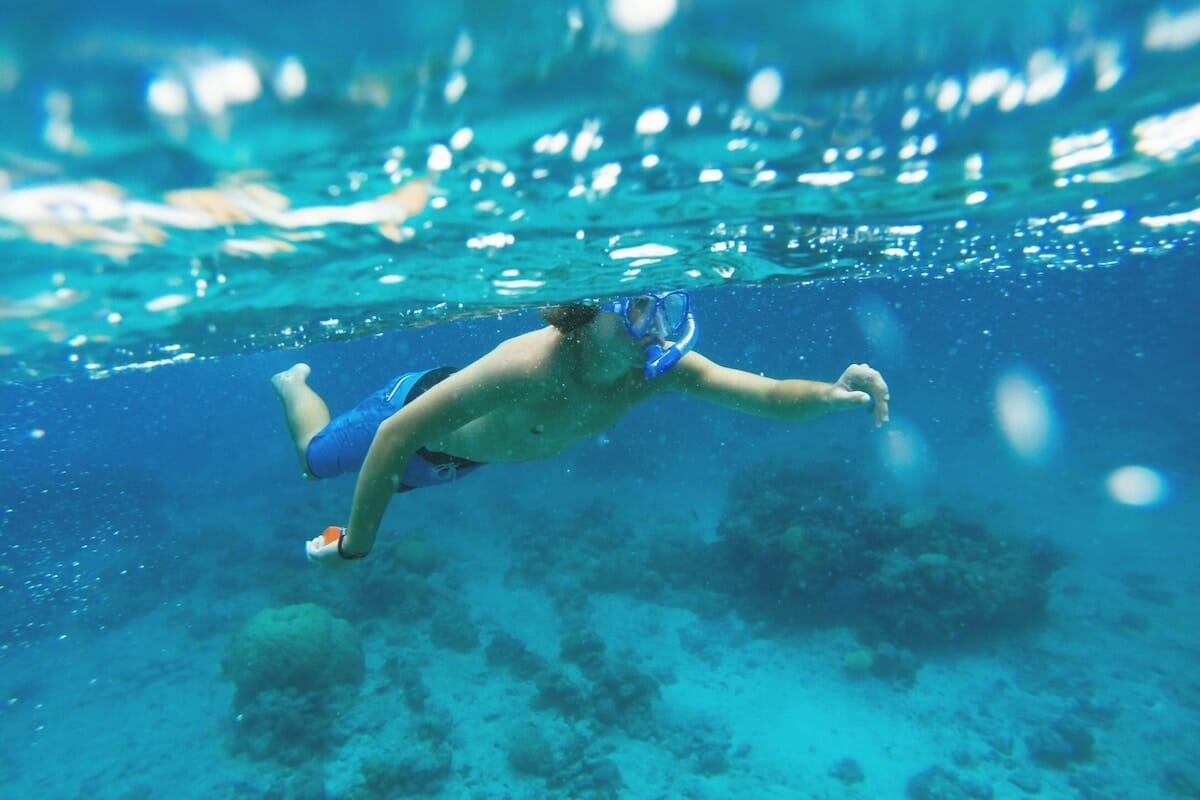 a child snorkeling underwater