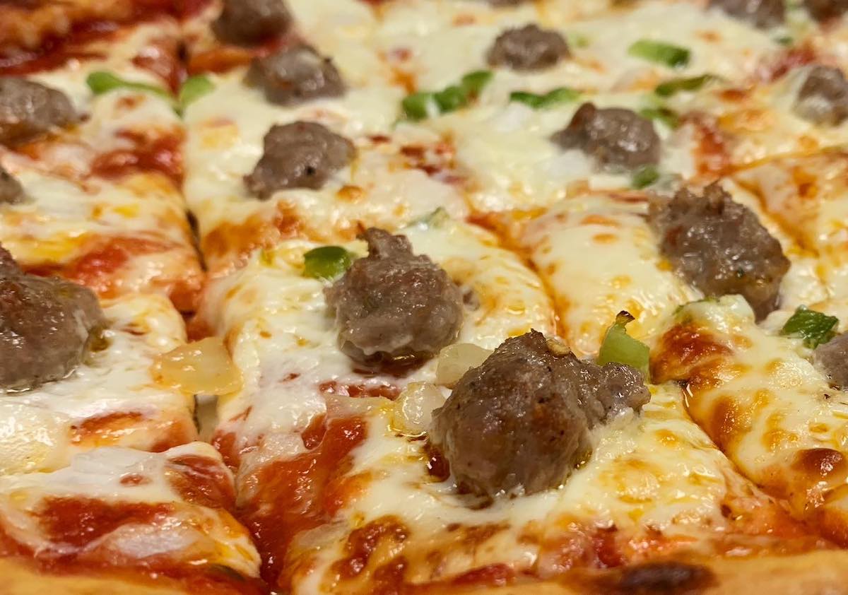 close-up of sausage pizza cut into square slices at Sammy's Pizza Duluth