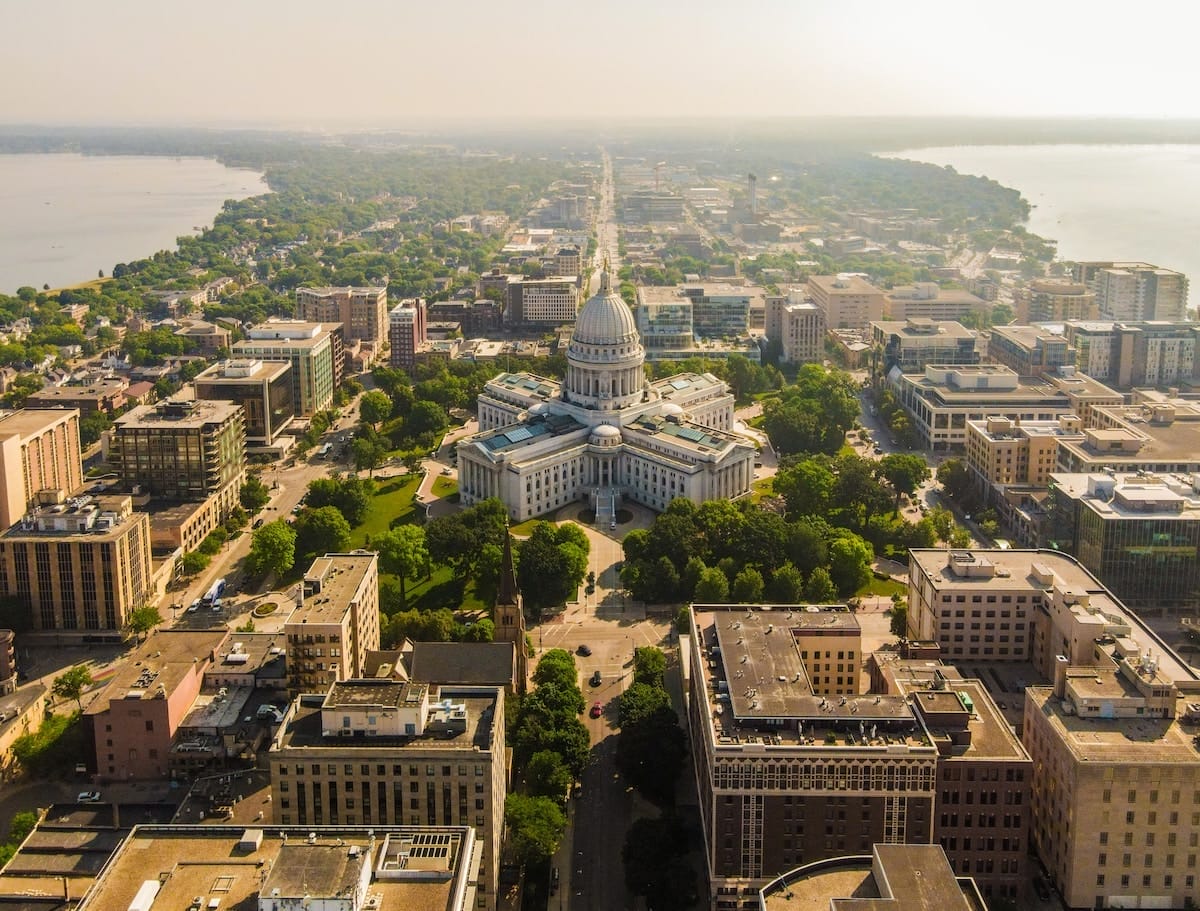 breathtaking aerial view of downtown Madison Wisconsin, one of the most beautiful places in America, with the prominent state capitol building surrounded by greenery in the center of it all