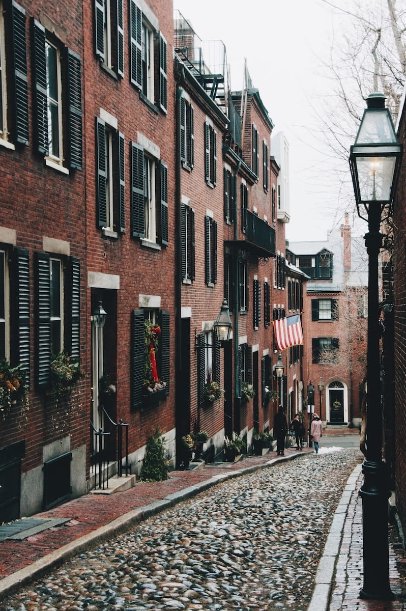 red brick buildings line a cobbled street in Boston, Massachusetts, one of the most beautiful places in America