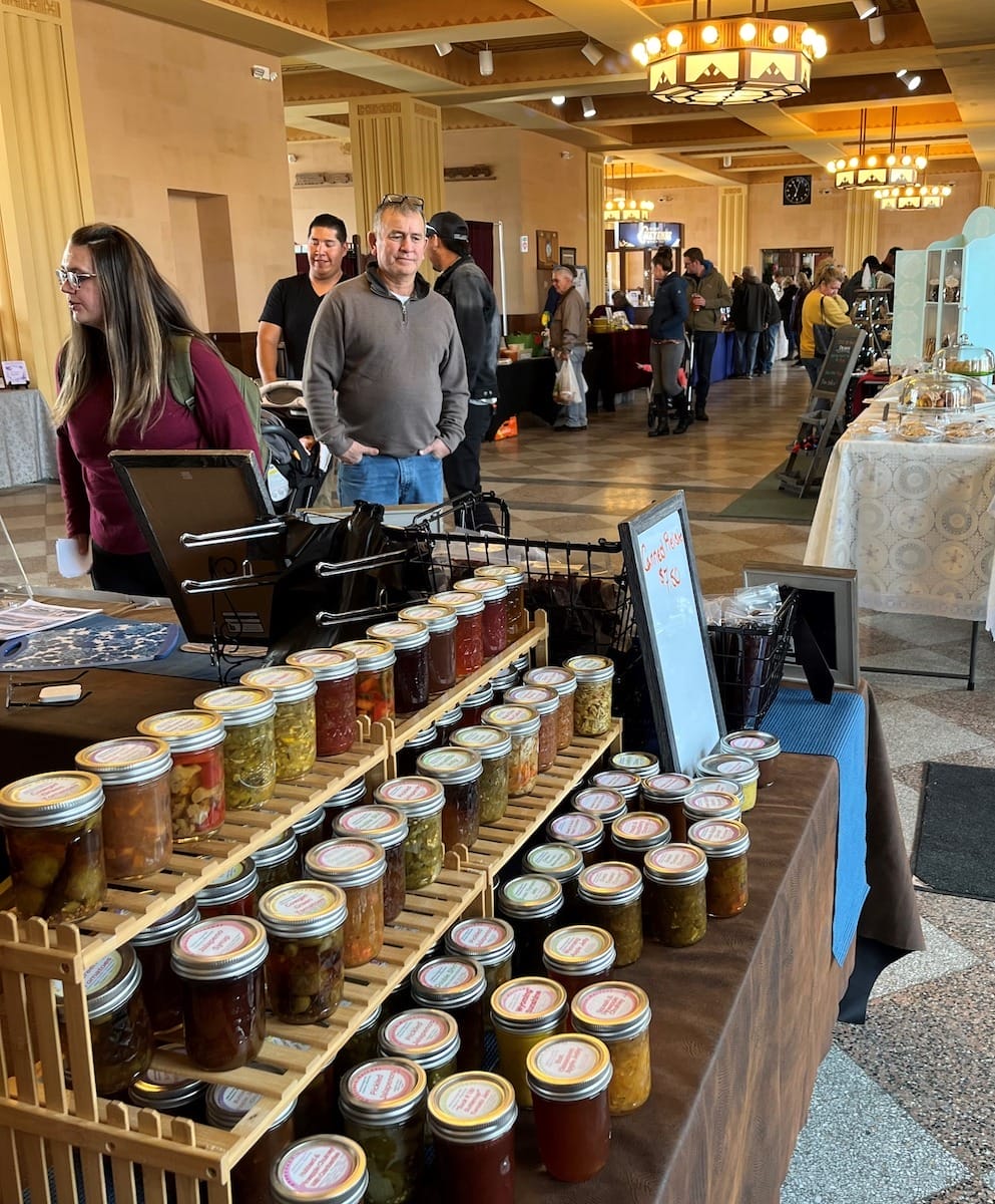 a vendor displaying jarred goods at the Cheyenne Winter Farmers' Market